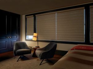Motorized blackout shades in a bedroom